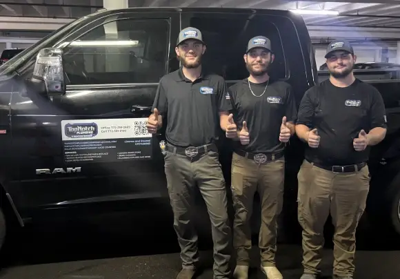 The Top Notch Plumbing crew giving thumbs up in front of a company truck in Port St. Lucie