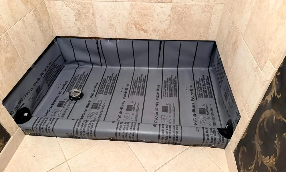 A shower pan liner installed during a bathroom remodel