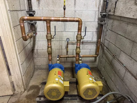 Two pumps connected to copper plumbing